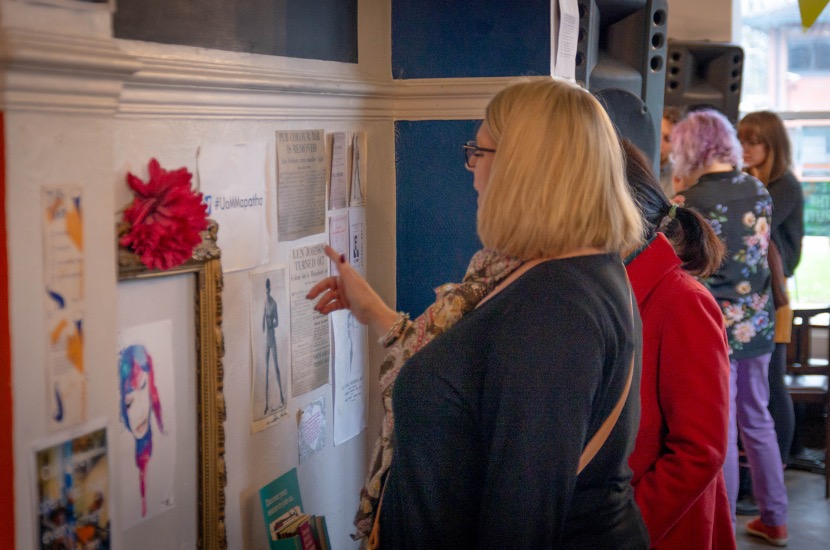 Event participant reading from an exhibit created by Dr Shirin Hirsch and Geoff Brown related to Len Johnson's historic protest at the Old Abbey Taphouse. Photo credit: Jenna Bowyer.